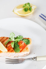 grilled salmon with cherry tomatoes and salad