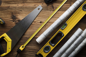 Construction and renovation concept. Contractor tools, on wooden table. Top view shot.