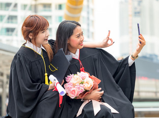 Young couple woman portrait smiling and selfie photo on her graduation day