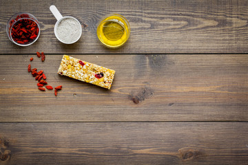 Granola bars with Goji berry on dark wooden background top view space for text