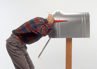 humorous funny profile of bent over man with head in mailbox 