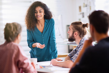 Meeting at office. a black woman talking with her colleagues 