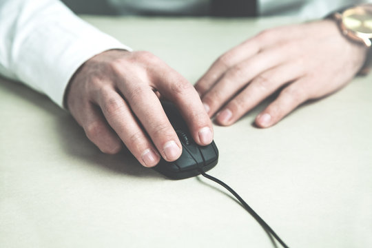 Businessman hand with computer mouse.
