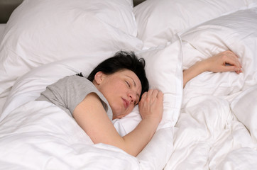 Fototapeta na wymiar Young woman enjoying a good restful sleep