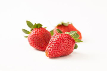 Ripe red strawberry on white table