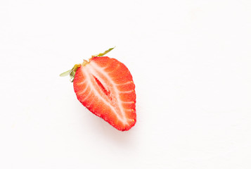 Ripe red strawberry on white table