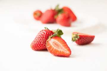 Ripe red strawberry on white table