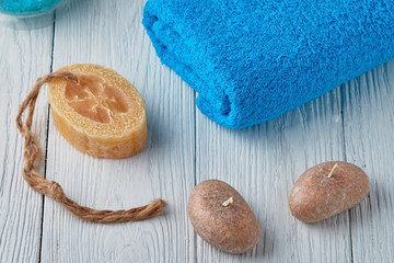 Spa concept. Colored towel, scented candles, handmade soaps on a white background.