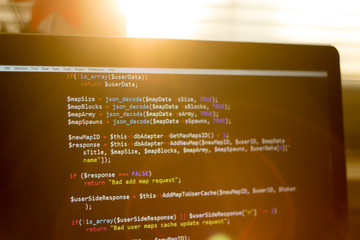 PHP back-end code in sunset rays. Computer programming source code. Abstract screen of web...