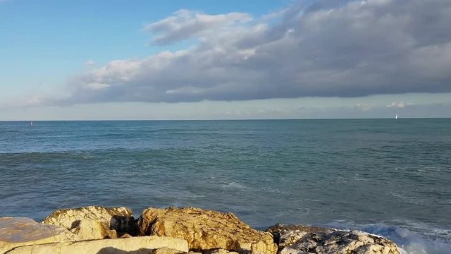 Waves crashing on seawall rocks in Denia, a Mediterranean Sea port in the Alicante province, on Costa Blanca, Spain. 