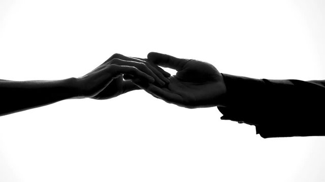 Male and female hands separating, relations breakup, divorce symbol, crisis