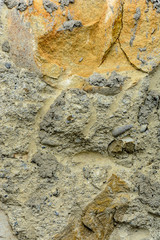 Wonderful background of gray concrete with a textured stone on the foundation