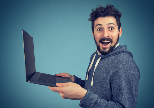 Surprised man with laptop computer