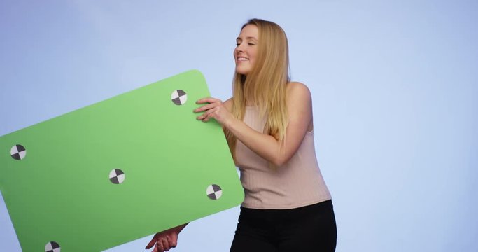 Hands are giving an oversized blank Card to a stunning smiling young lady