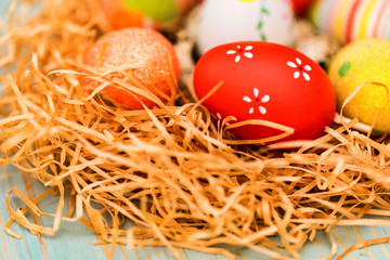 Several colorful Easter eggs in nest close