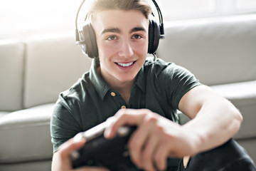 Young attractive man playing video games in the livingroom