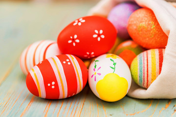 Several colorful Easter eggs in sack close