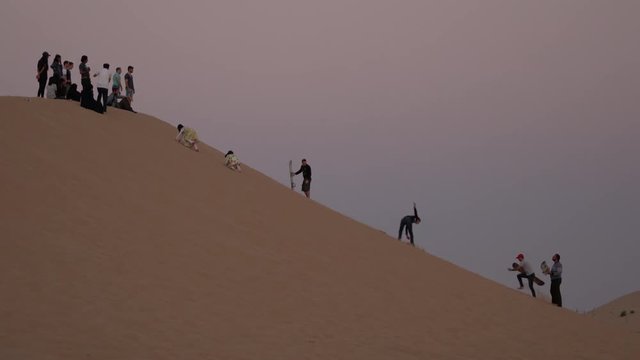 Sandboarding on a dune in the desert