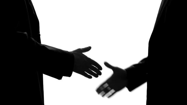Businessman giving suitcase and shaking hands, underground economy, illegal deal
