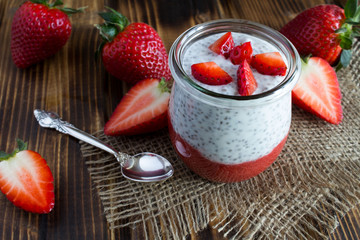 Pudding with chia and strawberry on the rustic wooden background