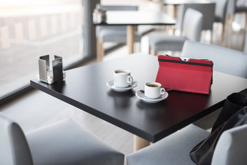 Table with cup of coffe and tablet