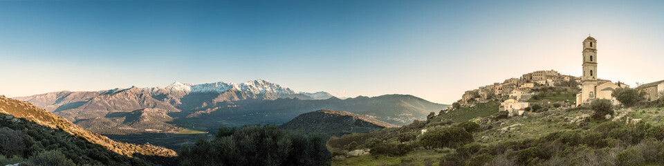 Panoramic view of Sant' Antonino and snow capped mountains in Corsica