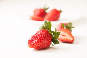 Ripe red strawberry on white table