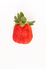 Ripe red strawberry on white table