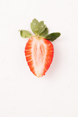 Ripe red strawberry on white table