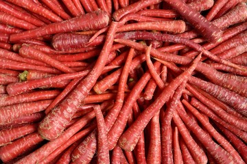 Indian Red Carrots, fresh harvested locally grown raw carrots in a farmers produce market in Rajasthan, India