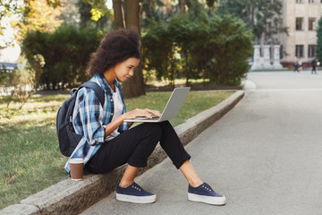 Young woman using laptop at university