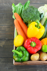 Raw vegetables on wooden table.
