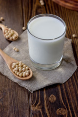 Soy milk with soy beans around it.