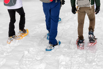 Snowshoe hike on the snowy mountain path. Walk on the fresh snow, using snowshoes.