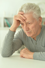 Sad senior man at home