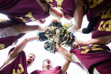 American Football Team players huddle after their victory - Powered by Adobe