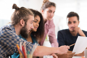 Young multiethnic creative team sharing ideas on a project 