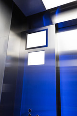 blank TV screen, LCD, in the Modern steel elevator interior in a business or Hotel, Store, interior, office.
