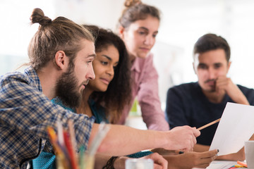 Young multiethnic creative team sharing ideas on a project 