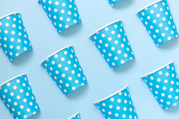 Obraz premium Diagonally positioned paper cups isolated on blue background. Minimalistic fashionable concept.