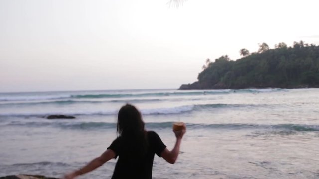 girl dances on the ocean shore.