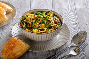 Soup lagman on a wooden table.