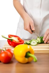 Chef woman cutting cucumber