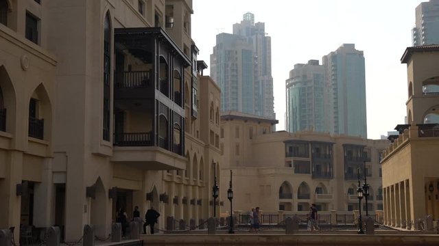 People walking on a walkway at Souk Al Bahar 
