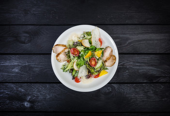 Grilled chicken breast salad, cherry tomatoes and iceberg salad.