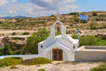 Traditional Greek whitewashed church in Agios Konstantinos on the island of Milos. Cyclades, Greece. © vivoo