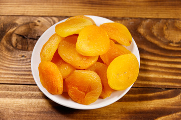 Naklejka na ściany i meble Dried apricots on wooden table