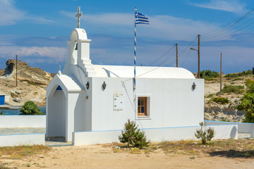 Traditional Greek whitewashed church in Agios Konstantinos on the island of Milos. Cyclades, Greece. © vivoo