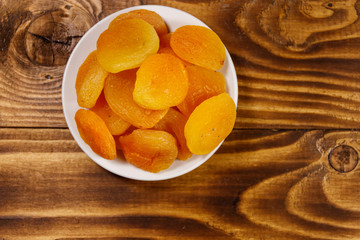 Dried apricots on wooden table. Top view