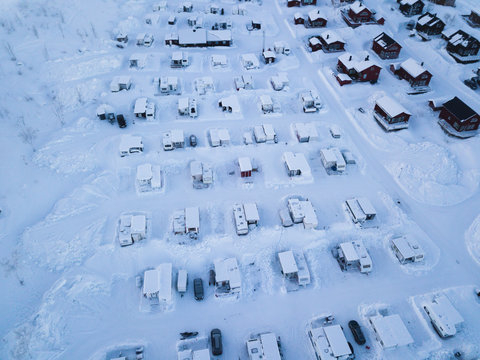 Aerial Winter View Of Camping Place With Caravans, Trailer Park And Cabin Cottage Houses, Northern Sweden, Near Border With Norway